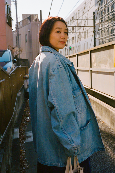 Mayumi wearing vowels Chore Jacket in Bleached Indigo